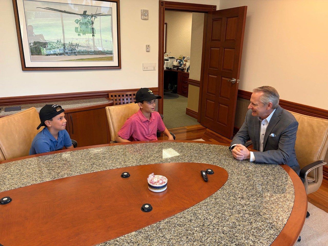 Sawyer and Parker Waldman, sons of Essex Industries CEO Evan Waldman, visit Sikorsky Vice President and General Manager Rich Benton at the Sikorsky offices in Stratford, Conn., Aug 20, 2026. The boys were rescued by Missouri National Guard crews in Sikorsky-made Black Hawk helicopters when their summer camp flooded and they, along with approximately 200 other children and adults, had to be evacuated. 